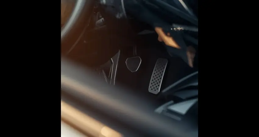 Driver struggling to figure out car pedals and indicators inside a vehicle