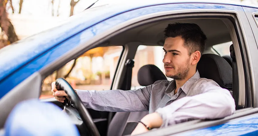 Driving student gaining confidence behind the wheel through regular practice and patience